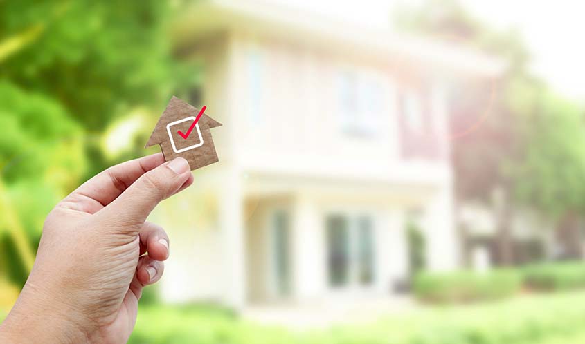 Hand Holding carboard House
