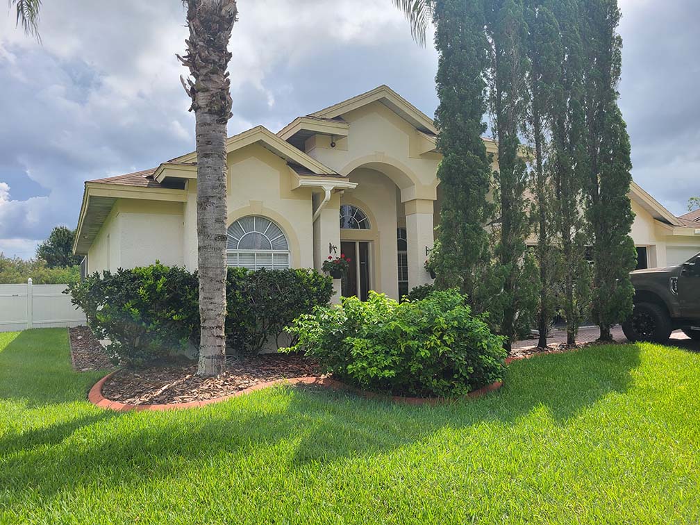 Florida House with green vegetation and truck